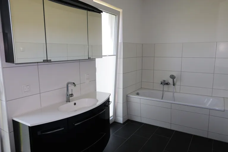 Badezimmer mit Badewanne und Waschtisch